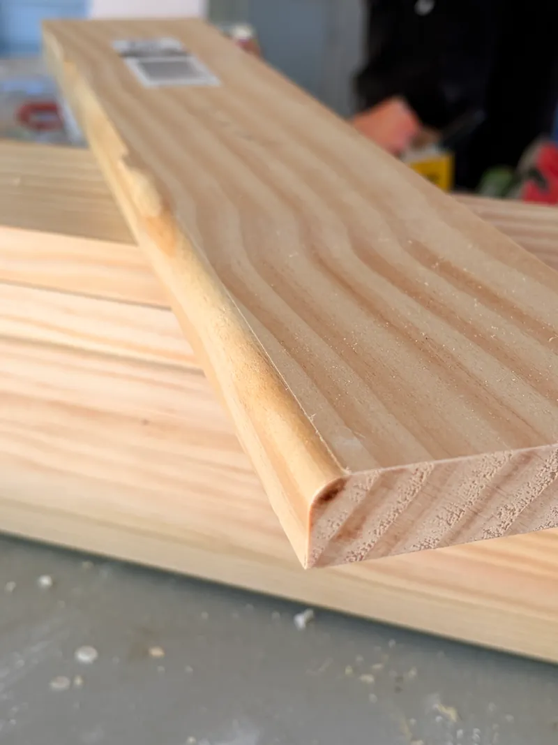Close-up of a clear pine board with a rounded edge on a workbench